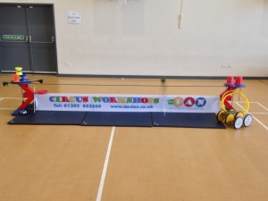 Child learning tight wire walking at a circus skills workshop