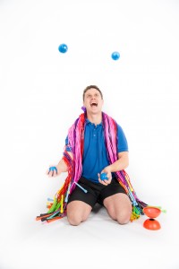 Child learning to juggle at a circus skills workshop