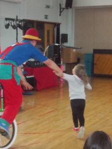 Mr Dan performing a circus skills comedy show for a school